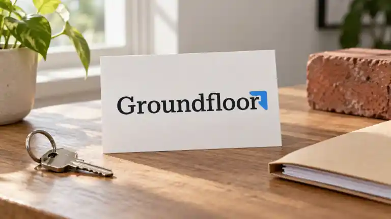Groundfloor logo card beside house keys, a folder and a brick